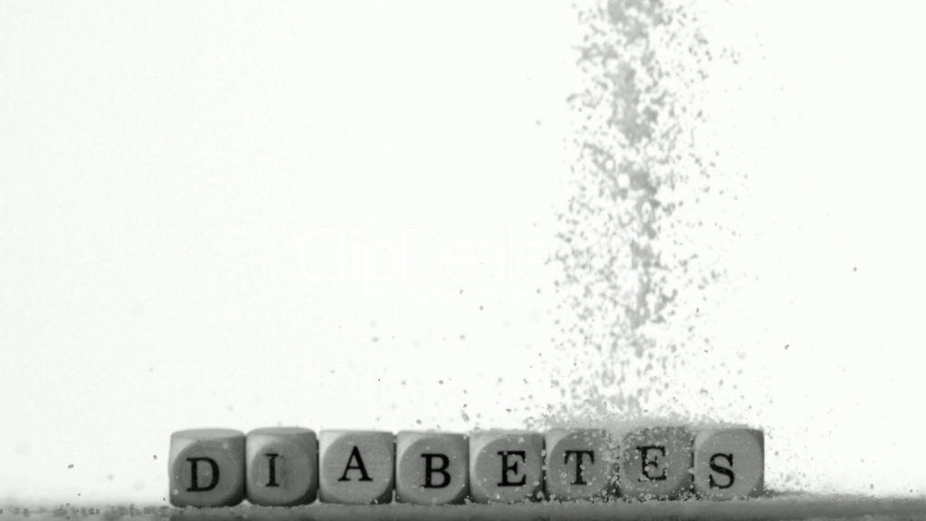 3--2494391-Sugar powder being poured over white dice spelling out diabetes